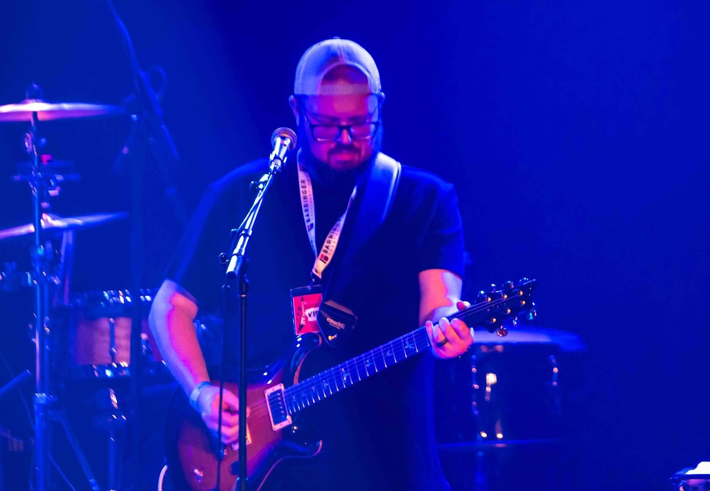 Mike performing on stage with guitar